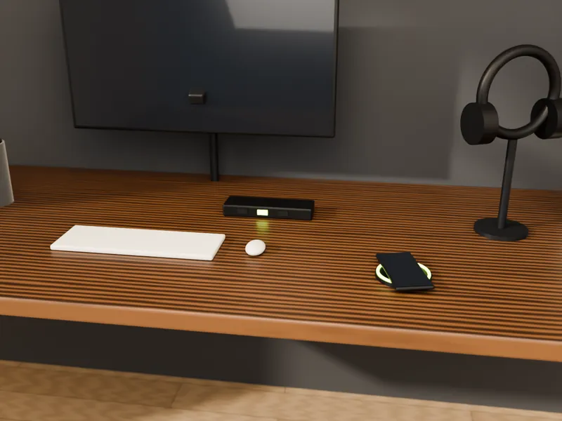 A walnut desk with a monitor arm, wireless charging pad, power module, headphones and a speaker